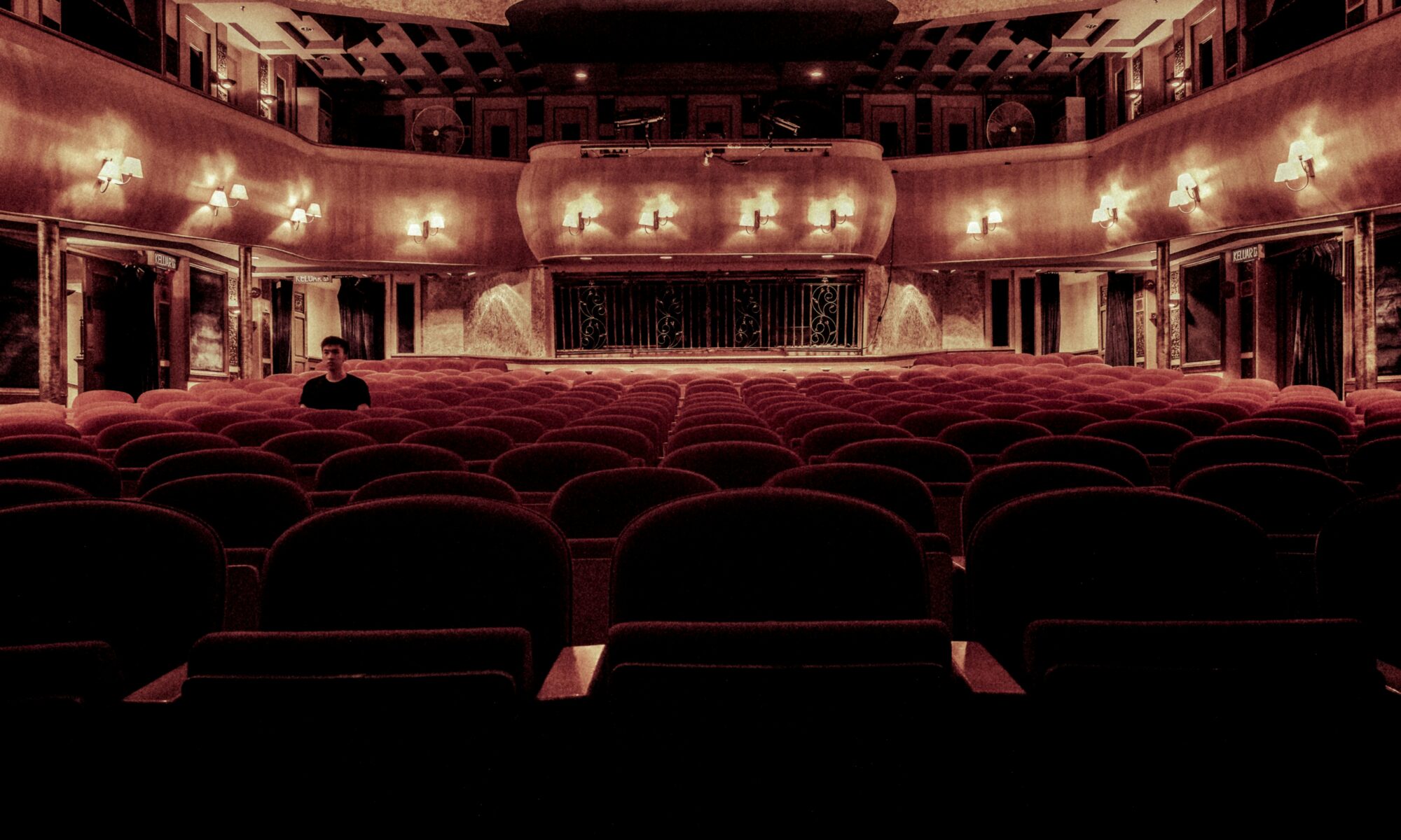 An elegant vintage theater with plush velvet seats and warm lighting, perfect for a serene cinematic experience.