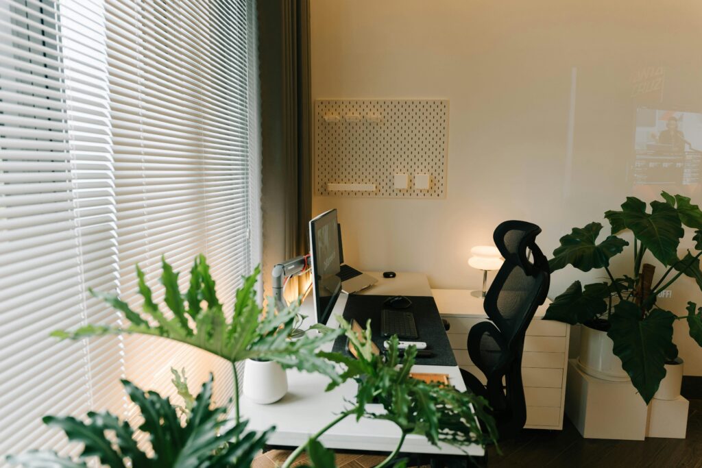 Bright modern home office space with plants and ergonomic chair.